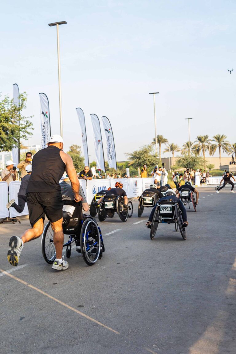 Wheelchair participants racing to the finish line at Zayed Charity Marathon Abu Dhabi 2022