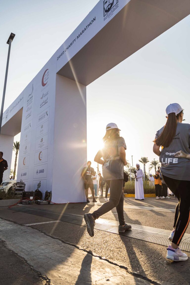 Two female runners crossing the finish line at the Zayed Charity Marathon Abu Dhabi 2022