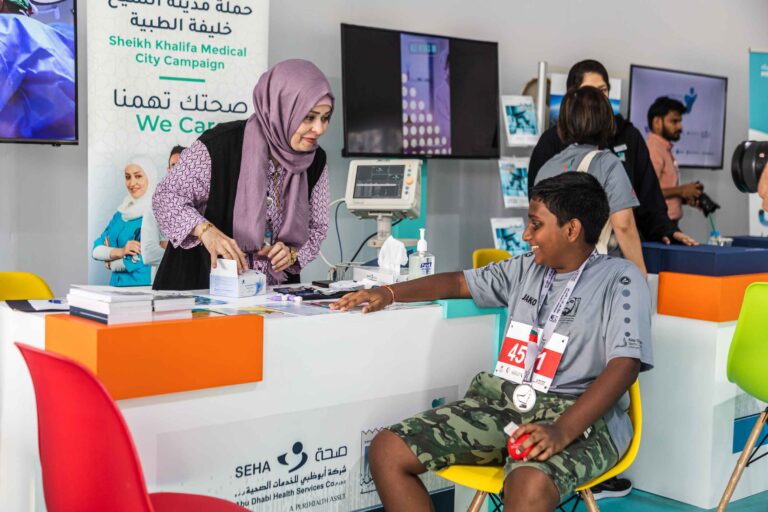 Runners in the Sheikh Khalifa Medical City Campaign booth at the Zayed Charity Marathon Abu Dhabi 2022