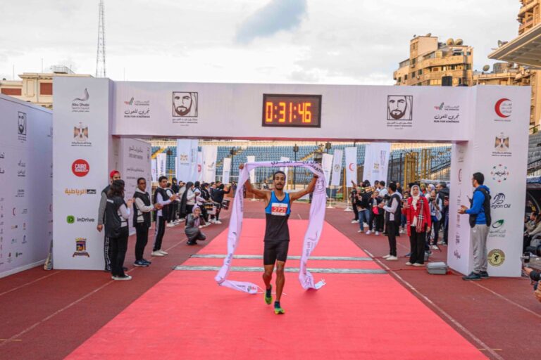Runner passing the finish line at Zayed Charity Marathon Egypt 2022